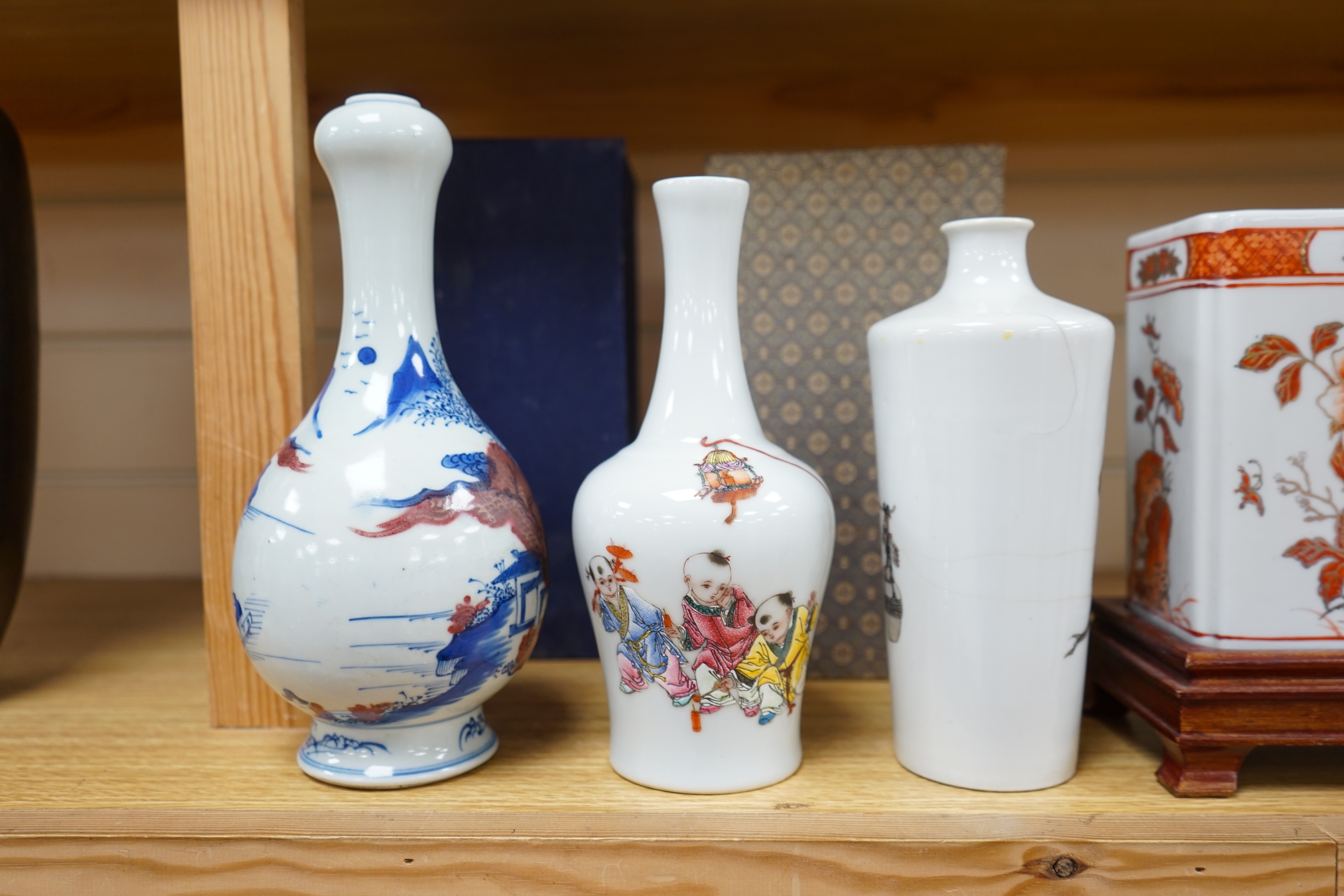 Two Chinese enamelled porcelain figure decorated vases, an underglaze blue and copper read garlic neck vase, and a rectangular jar with wood stand Condition - One vase cracked and chipped the rectangular jar lacking cove